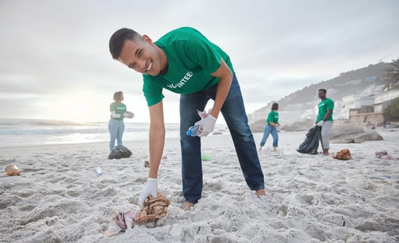 Volunteer portrait, beach cleaning or man for recycling plastic bottle for community service, pollution and earth day. Smile, ngo team or sand trash for climate change, nature and helping environment.