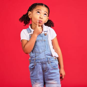 Kid, face or thinking finger on chin by isolated red background in games innovation, question or planning vision. Little girl, ideas or curious expression for child fashion clothes or curly hairstyle.
