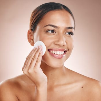 Cotton pad, skincare and woman with face beauty, facial treatment wellness and happy cleaning with skincare mockup. Skin, natural cosmetics and makeup removal, cosmetic care against studio background.
