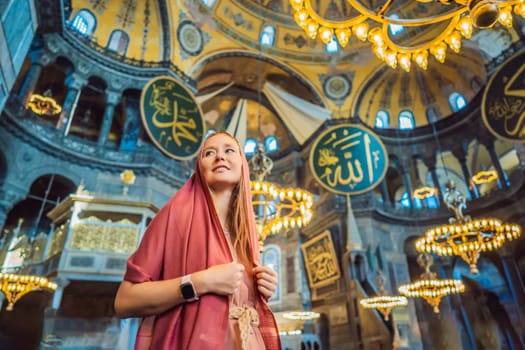 INSCRIPTION - denoting the names of Allah, the Prophet Muhammad, as well as the first 4 caliphs Woman tourist enjoying Hagia Sofia, Ayasofya interior in Istanbul, Turkey, Byzantine architecture, city landmark and architectural world wonder. Turkiye.