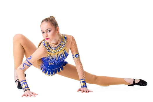 Young girl doing gymnastic exercises isolated. The girl in a blue dancing suit