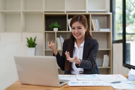 Asian Businessperson using laptop and celebrating victory and success, have good news, job celebrating achievement..