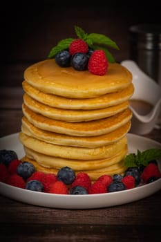 Recipe for maple syrup pancakes with raspberry and blueberry filling, High quality photo