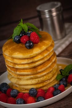 Recipe for maple syrup pancakes with raspberry and blueberry filling, High quality photo