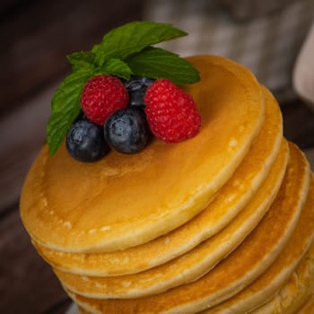 Recipe for maple syrup pancakes with raspberry and blueberry filling, High quality photo