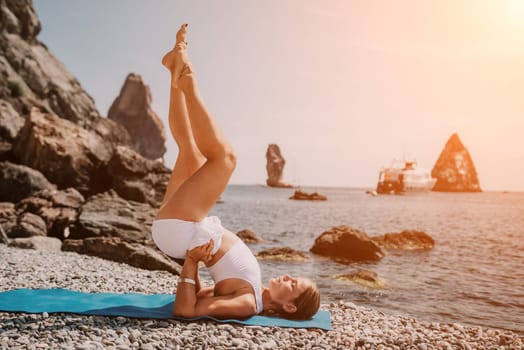 Woman sea yoga. Back view of free calm happy satisfied woman with long hair standing on top rock with yoga position against of sky by the sea. Healthy lifestyle outdoors in nature, fitness concept.