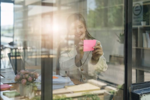 Asian Business person makes analysis and research financial report at office, analyzes profits. Accountant checks status of financial.