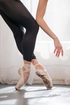 Close-up of the legs and arms of a ballerina