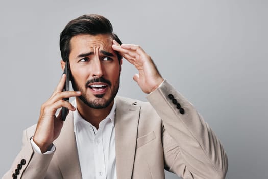 trading man smile call suit portrait angry guy business technology handsome beard smartphone connection confident application hold success phone cellphone studio