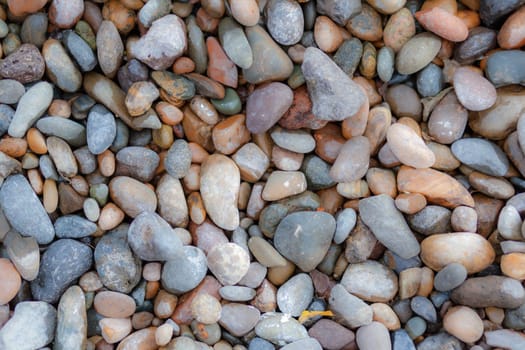 Crushed stone on the seashore. Selective focus on object. The stones were laid on the ground in the garden as a background. Background blur. Pebble stones background.