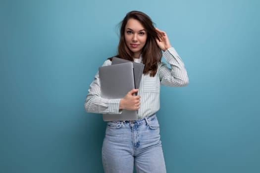 european slim 25 year old young brown-haired business woman holding a laptop for design.