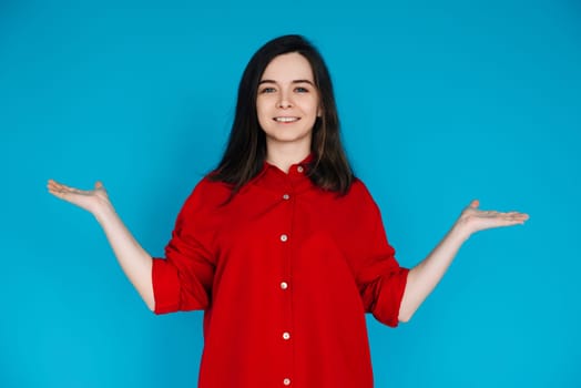 Young Woman Promoter Holding Hand Scales - Solutions, Comparisons, and Measurements - Advertising Concept - Isolated on Blue Background. Compare, Measure, and Advertise.