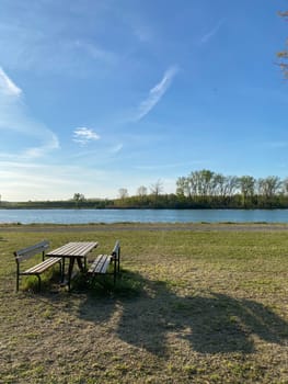 outdoors wooden public picnic table and seats near the river Po in Emilia Romagna, Italy