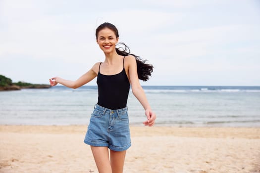 positive woman leisure lifestyle water space smile smiling running sea female vacation young active freedom body sunset beach walking travel copy summer