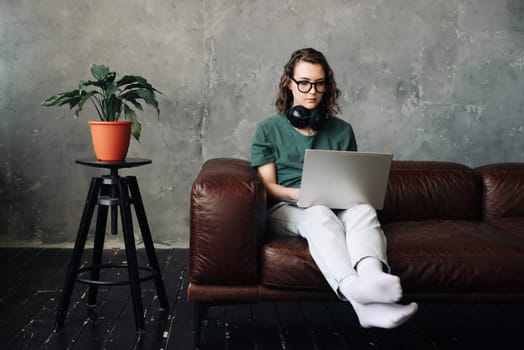 Digital Freelance Lifestyle: Young Woman Working or Studying from Home on Laptop - Emphasizing Remote Learning, Business, and Modern Living Concepts.