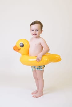 adorable boy with a float on a white background. Summer Vacation.