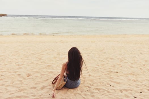 woman sand happy sea freedom ocean attractive nature female tropical back view sitting vacation sun natural summer travel beach pretty smile girl