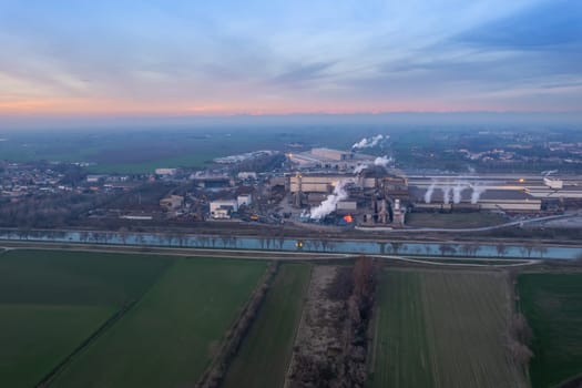 Cremona, Italy - January 2022 Drone aerial view of Arvedi working steel plant at dawn, industrial zone in Spinadesco, Cremona, Lombardy Italy