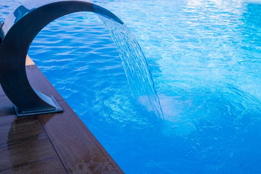 Empty Swimming pool with waterfall jet and jacuzzi in action