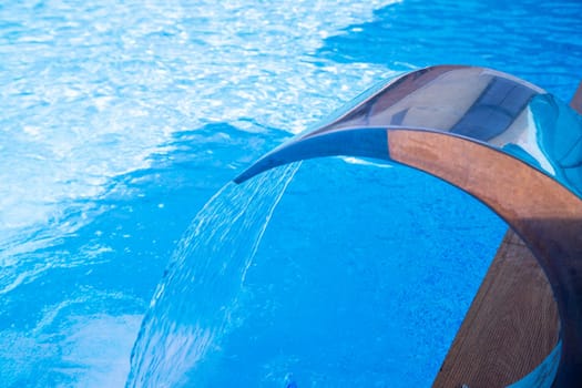 Empty Swimming pool with waterfall jet and jacuzzi in action