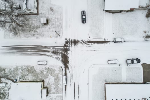 looking down at a snow covered intersection in a city
