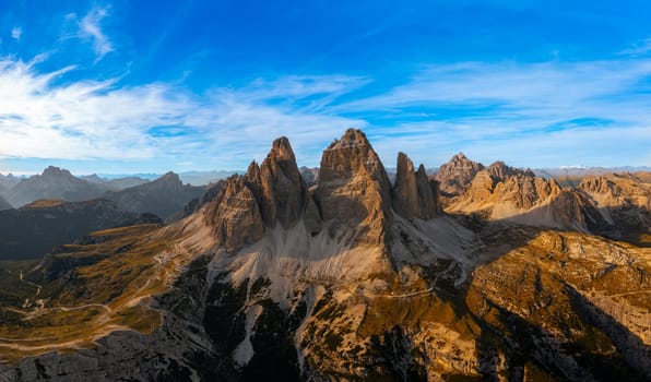 The rocky peaks of Tre Chime di Lavaredo sunset. The edges of the high peaks lighted by the rays of the sun