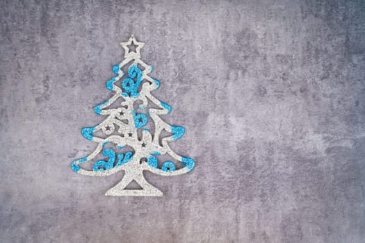Christmas tree for decoration on dark wall with empty space.