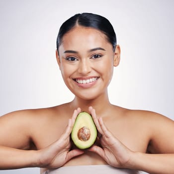 Happy woman, portrait and avocado in natural beauty, skincare or cosmetics against a white studio background. Face of female person smile, fruit or vegetable in healthy nutrition, fiber or wellness.