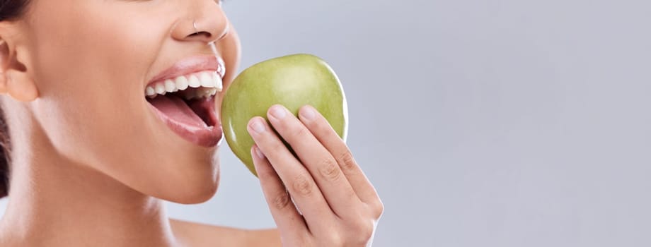 Mockup, apple bite or woman eating in studio on white background for healthy nutrition or clean diet. Closeup, space on banner or open mouth of hungry girl marketing natural green fruit for wellness.
