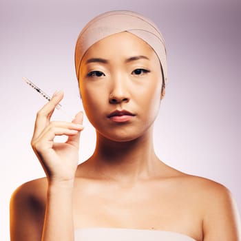 Woman, portrait and plastic surgery with injection, bandage and asian model in studio background. Serious woman, syringe and face with collagen for aesthetic, cosmetics and facial beauty treatment