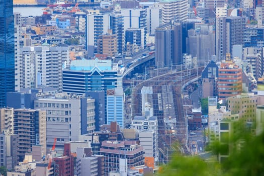 Train on tracks through multi-story buildings in dense city center. High quality photo