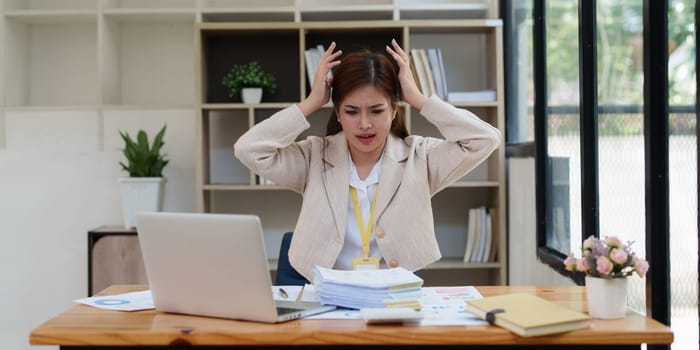 Deadline with young business woman feeling stressed concept. Business woman working at office, business finance concept.