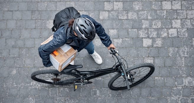 Delivery, package and man with a bicycle and box in the street for consumer order in the city. Transport, courier and male bike driver with stock with eco friendly transportation in the road in town