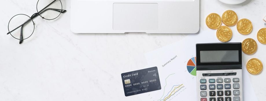 Concept of online payment with credit card with smart phone, laptop computer on office desk on clean bright marble table background, top view, flat lay