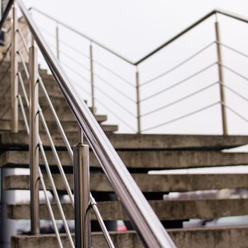 Staircase with metal railing on the sky background