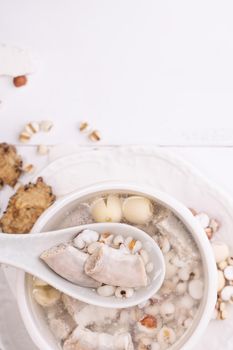 Tasty Four Tonics Herb Flavor Soup,Taiwanese traditional food with herbs,pork intestines on white wooden table,close up,flat lay,top view