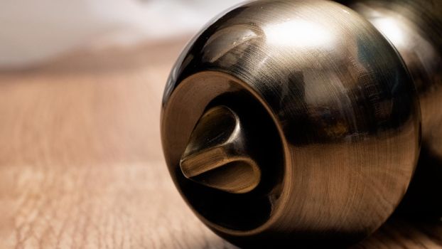 Round doorknob system on a wooden background close up