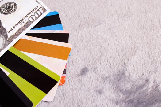 Dollar bill and bank cards on a gray background