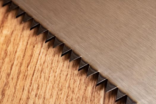Saw blade close up on a wooden background