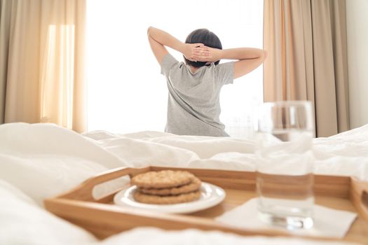 Tray with breakfast on a bed in a hotel room