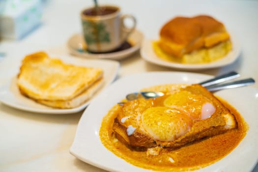 Eggs, toast with Kaya and Butter and coffee, traditional breakfast meal in Kuala Lumpur