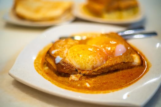 Eggs, toast with Kaya and Butter and coffee, traditional breakfast meal in Kuala Lumpur