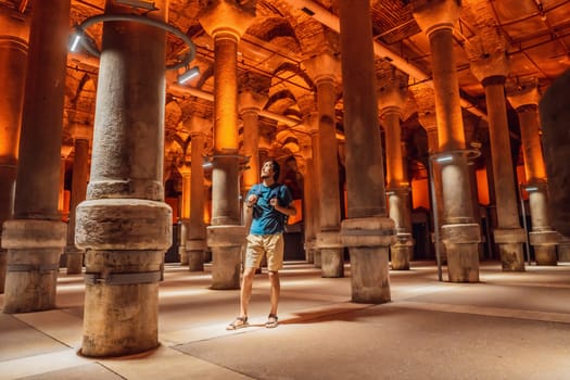Man tourist enjoying Beautiful cistern in Istanbul. Cistern - underground water reservoir build in 6th century, Istanbul, Turkey, Turkiye.
