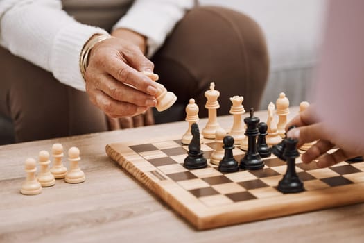 People, playing hands or chess knight on house, home or living room table in strategy board game, checkmate vision or contest. Zoom, women or competition friends and chessboard pawn in mind challenge.