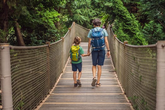 father and son tourists in Rope bridge in Yildiz Park. Besiktas, Istanbul, Turkey. Turkiye. Traveling with kids concept.