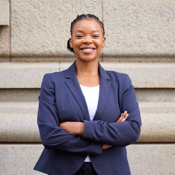 Mission, vision and mindset with a business black woman standing arms crossed outdoor in the city alone. Success, motivation and growth with a female employee looking confident in an urban town.