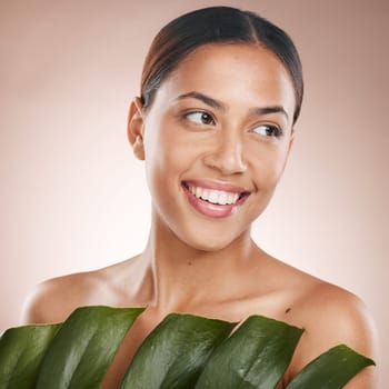 Woman, face skincare and monstera leaf on pink studio background for organic dermatology, self love or healthcare wellness. Happy, smile or beauty model with green plant, natural makeup or cosmetics.