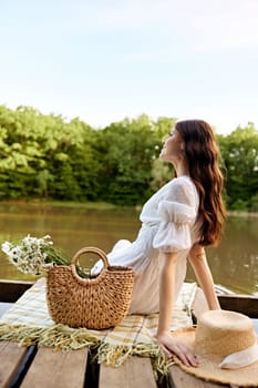 close up photo of a woman sitting by the lake with a wicker bag full of daisies. High quality photo