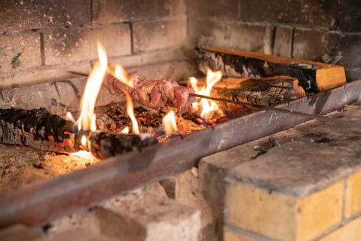 Marinated shashlik preparing on a barbecue grill over charcoal. Shashlik or Shish kebab popular in Eastern Europe.
