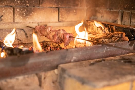 Marinated shashlik preparing on a barbecue grill over charcoal. Shashlik or Shish kebab popular in Eastern Europe.